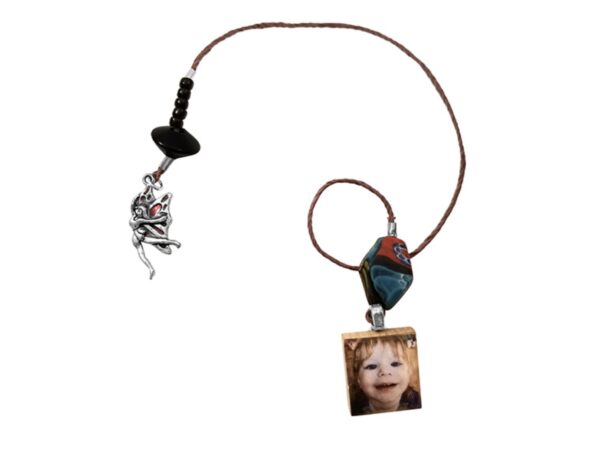 a necklace with a picture of a child on it