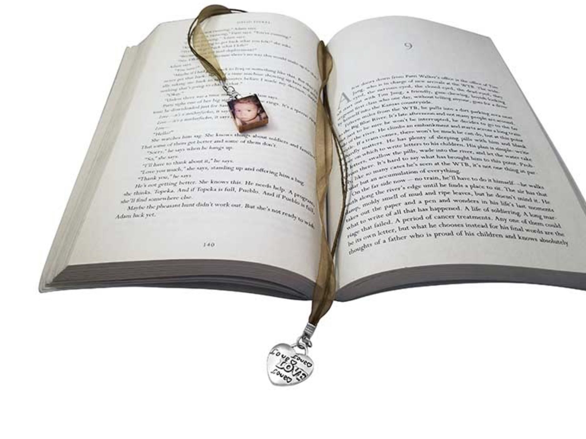 an open book with a dog tag attached to it