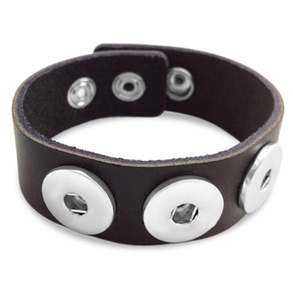 a black leather bracelet with two metal buttons