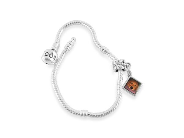 a silver bracelet with a dog charm on it
