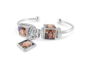 a silver bracelet with two pictures on it