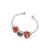 a red bracelet with three charms on it