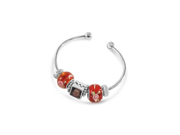 a red bracelet with three charms on it