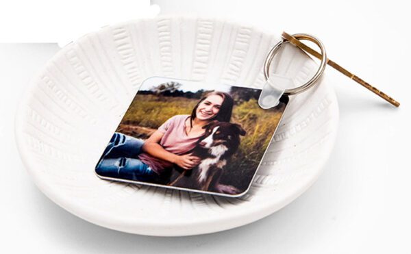 a white plate with a photo of a woman and a dog on it
