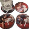 four coasters with pictures of people and dogs on them