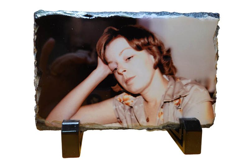 a photo of a woman is on a shelf small personalized photo slate